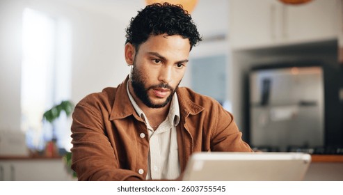 Reading, tablet and remote work with man in kitchen for research, blog writer and news post. Entrepreneur, freelancer and online feedback with person at home for media update, startup and planning