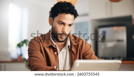 Reading, tablet and remote work with man in kitchen for research, blog writer and news post. Entrepreneur, freelancer and online feedback with person at home for media update, startup and planning