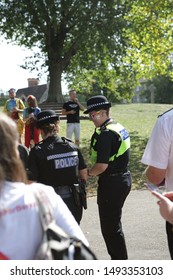 Reading, UK Aug 31st 2019. Female Police Officer At Reading Pride Parade 2019, With Rainbow Sunglasses And Glitter On Her Face; Smiling And Talking With Another Female Police Officer.