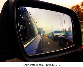 Reading, UK - December 1 2018: Looking At Queuing Traffic In The Wing Mirror Of A Car.