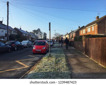 Reading, UK - November 22 2018: A Cold Morning, Grass Is Covered In Frost As Parents Return Home Having Dropped Their Children At School.