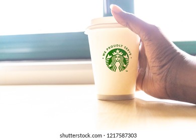 Reading, United Kingdom- October 31-2018 : Brown Skin Woman Holding A Cup Of Starbucks Coffee