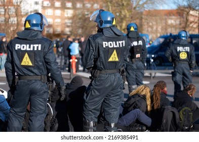 Ready For Anything. Rearview Shot Of A Police Man In Riot Gear.