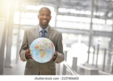 Ready To Conquer The Business World. Cropped Portrait Of A Businessman Holding A Globe.