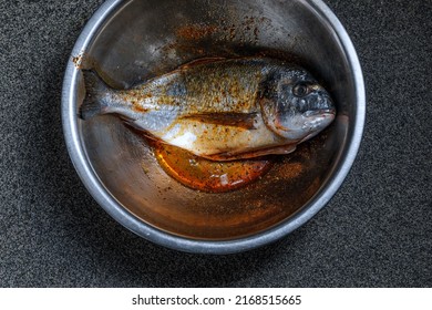 Ready To Cook Whole Marinated Sea Bream In Metal Mixing Bowl Dish.Top View