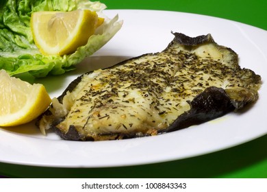 Ready Cooked, Fried, Grilled Plaice Fish Fillet In A Plate. Green Background.