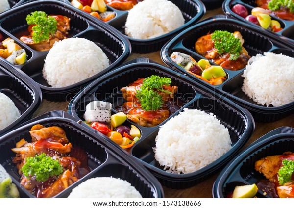 Ready to eat asian rice box, Thai food in take\
away plastic boxes.
