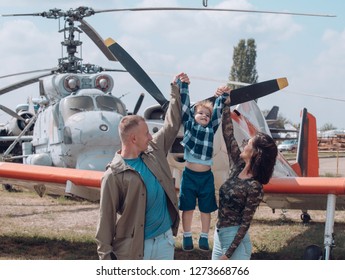 Ready To Fly High. Happy Family Vacation. Family Couple With Son On Vacation Travel. Woman And Man With Boy Child At Helicopter. Air Tour And Travel. Enjoying Travelling By Air.