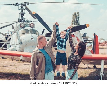 Ready To Fly High. Happy Family Vacation. Family Couple With Son On Vacation Travel. Woman And Man With Boy Child At Helicopter. Air Tour And Travel. Enjoying Travelling By Air.