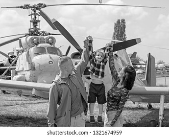 Ready To Fly High. Happy Family Vacation. Family Couple With Son On Vacation Travel. Woman And Man With Boy Child At Helicopter. Air Tour And Travel. Enjoying Travelling By Air.