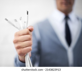 Ready To Get Wired Up. A Young Nerdy Guy Holding Usb Cables Toward The Camera.