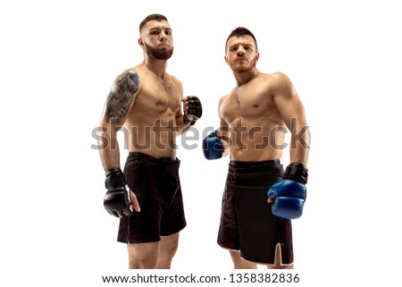 Ready to grow up. Two professional fighters posing isolated on white studio background. Couple of fit muscular caucasian athletes or boxers standing. Sport, competition and human emotions concept.