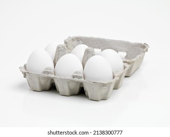 Ready to make an awesome breakfast. Studio shot of half a dozen white eggs in a carton.