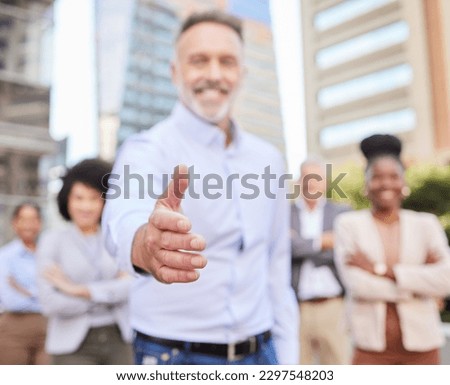 Ready to make the change. an unrecognisable businessman standing with his hand outstretched for a handshake while his colleagues stand behind him.