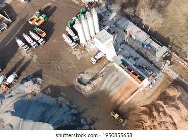 Ready Mix Concrete Batching Plant. Producing сoncrete And Portland Cement Mortar For Construction And Formworks. Pouring Concrete Through To A Ready-mixed Truck. Drone View. Out Of Focus