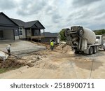 Ready mix truck pouring a concrete driveway