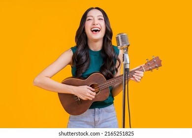 Ready To Party Cheerful Asian Female Woman Signing Joy Fun Toothy Smile Big Laugh Wearing Casual Cloth Freshness Action Pose Pretending Perform In Concert Studio Shot On Yellow Background