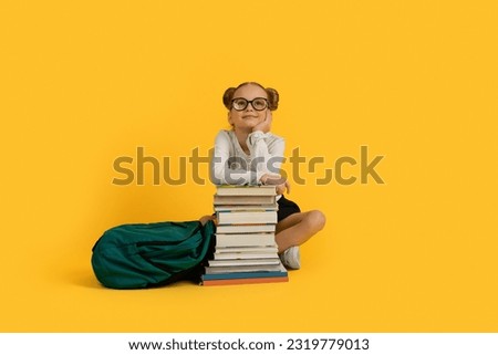 Ready For School. Dreamy Little Girl Sitting With Backpack At Stack Of Books Over Yellow Studio Background, Cute Preteen Female Child In Eyeglasses Dreaming About First Day In School, Copy Space