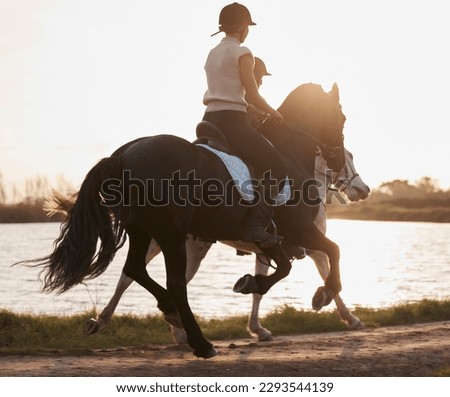 Ready for something completely different. Shot of two young women out horseback riding together.