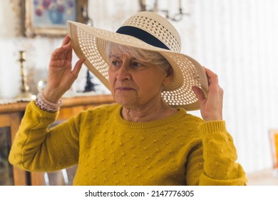 Ready For Summer - Senior Woman In Hat At Home Medium Closeup Living Room Seniority Concept. High Quality Photo