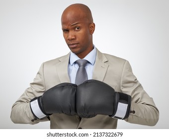 Ready To Take On All Business Competition. Studio Shot Of An African American Businessman Wearing Boxing Gloves.