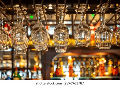 Ready to use wine glasses above a bar, with selective focus - Powered by Shutterstock