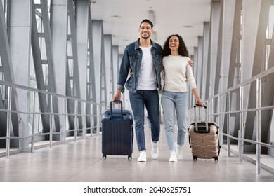 Ready For Vacation. Romantic Middle Eastern Couple Walking With Suitcases At Airport Terminal, Happy Arab Spouses Embracing While Going To Boarding Gate, Enjoying Travelling Together, Copy Space - Shutterstock ID 2040625751