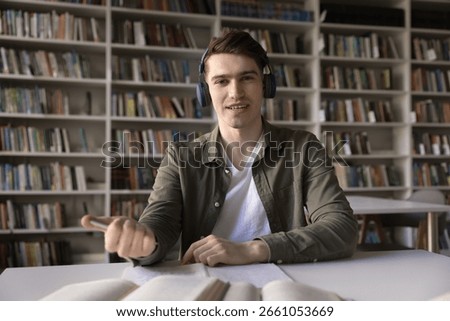 Ready for virtual class. Webcam portrait confident young man distance learning student sit at desk in digital headphones prepare for video lecture group conference with teacher click pen to take notes