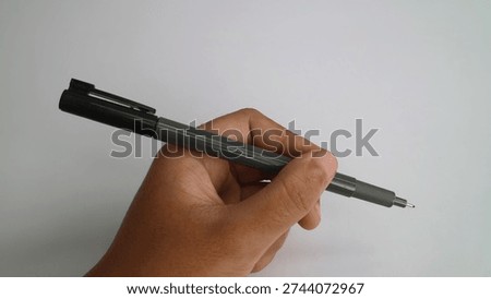 Ready to Write: Hand Holding a Precision Fineliner Pen