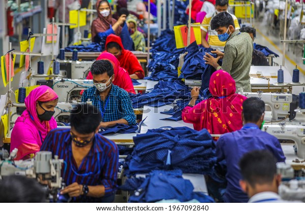 Readymade garments workers work\
in a factory during a coronavirus pandemic in Gazipur on May 2,\
2021. 