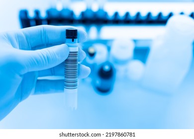 Reagent tubes and bottes for laboratory analysis automate machine.Sample specimen in test tube and chemistry and immunology reagent bottle on white table background for laboratory analysis. - Shutterstock ID 2197860781