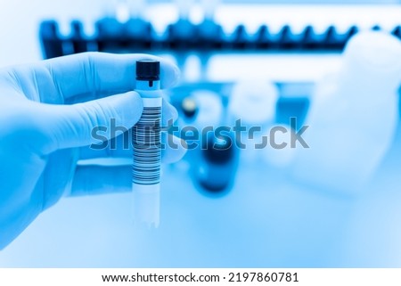 Reagent tubes and bottes for laboratory analysis automate machine.Sample specimen in test tube and chemistry and immunology reagent bottle on white table background for laboratory analysis.