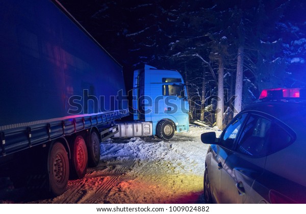 A real\
accident. Truck traffic accident at night, on a snowy winter\
road.\
Broken truck on the road in the\
snow.