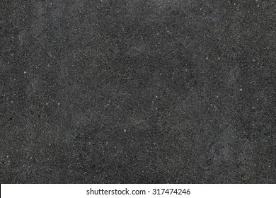 Real asphalt texture background. Coloured dark black asphalt pattern. Grainy street detail gray textured background. Best way show your design or illustration with this actual asphault photo texture.