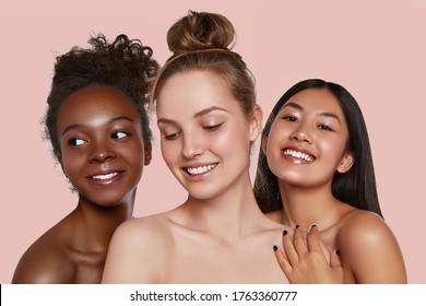 The real beauty exists in every corner of the world and is presented by women of all races. Beauty portrait of three smiling ladies with different skin colour.