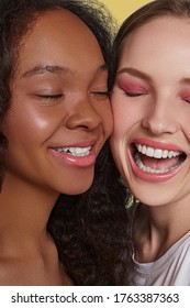 The real beauty exists in every corner of the world and is presented by women of all races. Cropped portrait of two beautiful laughing girls with different skin and hair colour posing cheek to cheek. 