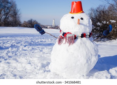 Real Big Snowman With Red Hat In Snow Park