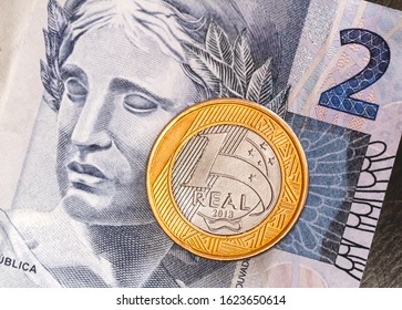 
Real - Brazilian Currency. Money, Dinheiro, Brasil, Brazil, Reais. One Real coin on a two Real banknote.