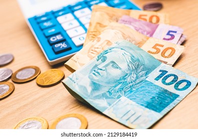 Real - Brazilian money. Brazilian Real banknotes on a wooden surface e with a calculator in the image composition. Concepts of Brazilian economy, investments, finance and debt.
 - Shutterstock ID 2129184419