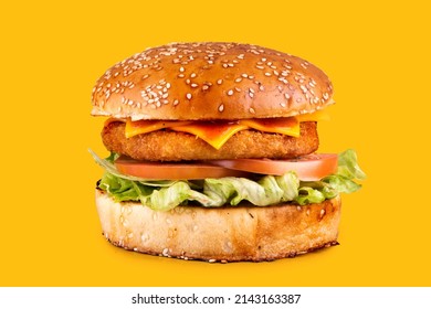 Real Breaded Chicken Burger With Cheddar And Buffalo Sauce Isolated On Yellow Background