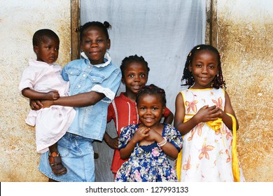 Real Candid Family Photo Of Five Cute And Sweet Black African Sisters Or Girls, All Smiling In Their Sunday Dress, Perfect For Developing Country And Third World Population Issues.