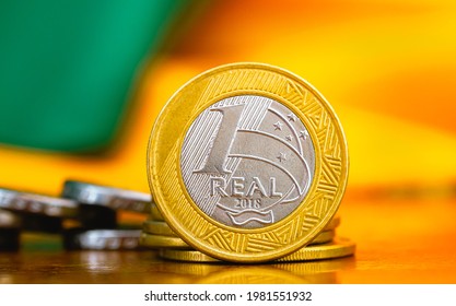 Real Currency, Money from Brazil. A group of Brazilian coins on a wood object. Finance and Brazilian economy concepts. Close up photo.