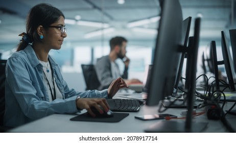 Real Diverse Office: Indian IT Programmer Working On Desktop Computer. Female Specialist Creating Innovative Software. Engineer Developing App, Program, Video Game. Writing Code In Terminal.