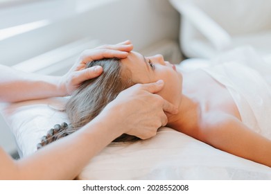 real doctor osteopath hands does physiological and emotional therapy for eight year old kid girl. pediatric osteopathy treatment session. alternative medicine. taking care of the child's health