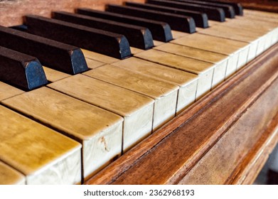 real elephant ivory piano keys on old wooden grand piano black and white keys with dirt, sweat and finger oils pattern detail late 1800s instrument, worn and well played top angled view - Powered by Shutterstock
