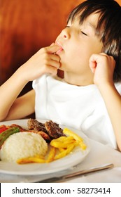 Real Enjoying Food, Cute Kid With Finger In His Mouth