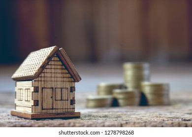 real esatae investment,image of house model with stack of coins.