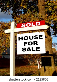 Real Estate Advertising Sold Rider Insert Over Home Owner House For Sale Sign On A Wood Post In A Residential Neighborhood Street