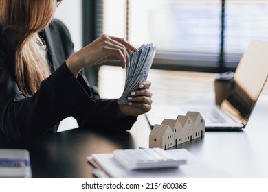 Real Estate Agent Businesswoman Counting Cash, Deposit Or Commission On Real Estate Sales.