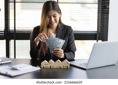 Real Estate Agent Businesswoman Counting Cash, Deposit Or Commission On Real Estate Sales.